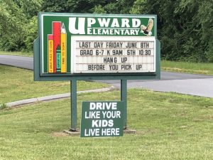 Upward Elementary sign with "Drive Like Your Kids Live Here" sign below.