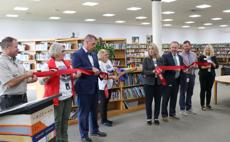 Jay Egolf, Shelia Dale, HCPS Superintendent Mark R. Garrett, Henderson County Commissioners Board Chair Rebecca McCall, Maggie Gilliam Henderson County Pathfinders Program Director, Brandon Scott East Henderson High School Principal, Brent Stepp Flat Rock Middle School Principal, Peggy Marshall Henderson County Education Foundation Director stand with the ribbon during the cutting ceremony.